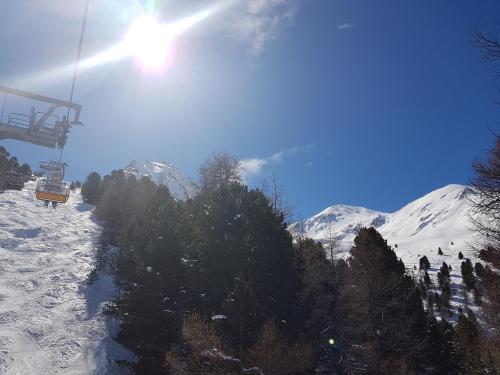 a ski lift going up a snow covered mountain at Apart-Garni Motnaida in Samnaun