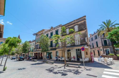a street in a city with buildings and trees at Hort de Can Bou in Porreres