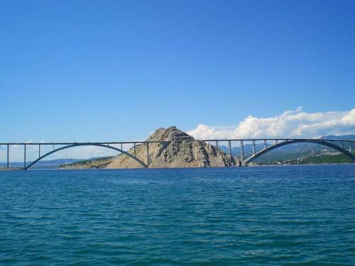 a bridge over a large body of water at Apartments Michael & Petra , Omisalj, Insel Krk, Kroatien in Omišalj