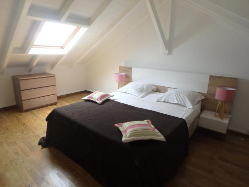 a bedroom with a large bed with two pillows on it at Cap Est in Le Moule