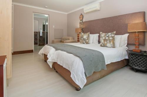 a bedroom with a large bed in a room at Whale Away Guest House in Hermanus