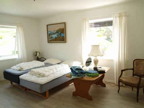 a bedroom with a bed and a table at Apartment in Herand, Hardanger in Herand