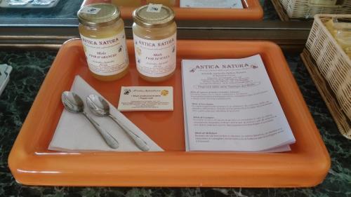 an orange tray with silverware on a table at Cartoline Dall'Etna B&b in Zafferana Etnea