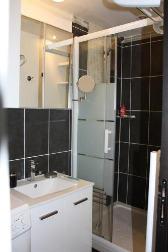 a bathroom with a sink and a shower at Appartements à Deauville dans Triangle d'Or in Deauville