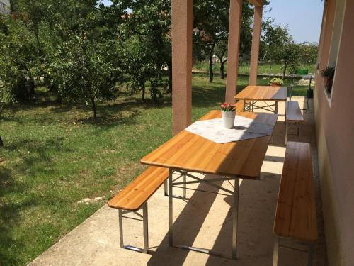 two picnic tables on the porch of a house at Middle Istra in Pazin