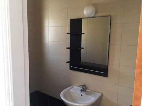 a bathroom with a sink and a mirror at Menelaos Villa 9 in Paralimni