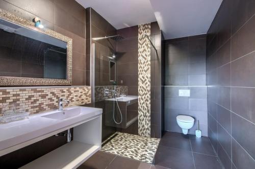 a bathroom with a sink and a shower and a toilet at Rooms K&T sea side luxury in Pula