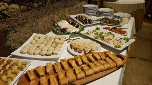 a table with many different types of food on it at Riviera Hotel in Enna