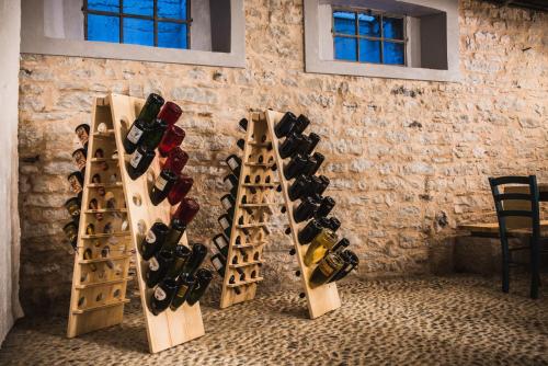 a bunch of wine bottles lined up against a wall at Locanda Solagna in Quero