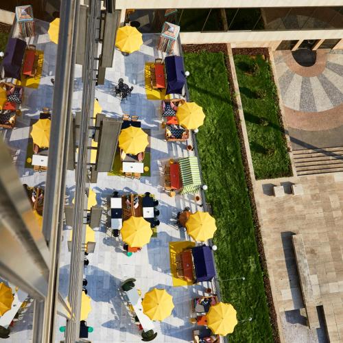 an overhead view of a table with yellow umbrellas at Mama Shelter Prague in Prague