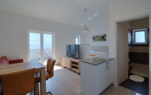 a living room with a kitchen and a dining room at BC Eleven - mit Zentralheizung in Senj