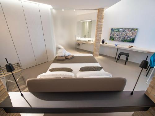 a room with two beds and a desk at Serre Alte Landscape Luxury Rooms in Matelica