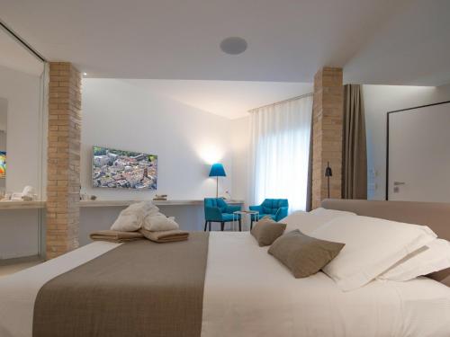 a bedroom with a large bed and a table at Serre Alte Landscape Luxury Rooms in Matelica