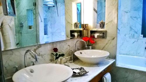 a bathroom with a white sink and a mirror at Palais Faraj Suites & Spa in Fès
