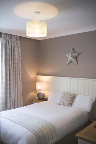 a bedroom with a bed with a star on the wall at George Hotel, BW Signature Collection in Norwich