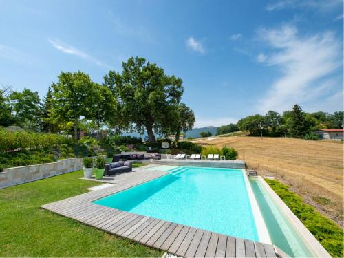 a swimming pool in the yard of a house at Serre Alte Landscape Luxury Rooms in Matelica