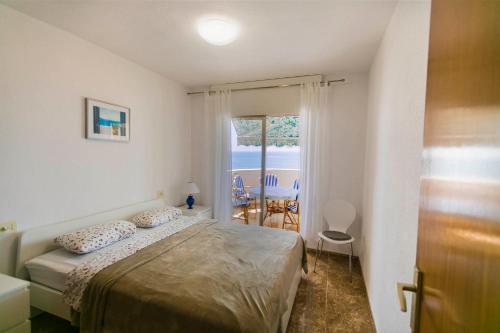 a bedroom with a bed and a view of the ocean at Las Gondolas Seaview in La Manga del Mar Menor