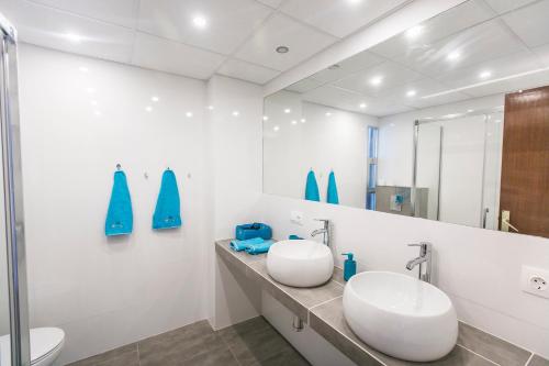 a bathroom with two sinks and a mirror at Las Gondolas Seaview in La Manga del Mar Menor