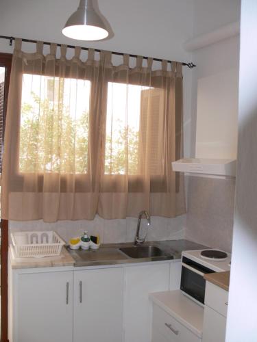 a kitchen with a sink and a window at Eleni Apartments in Preveza