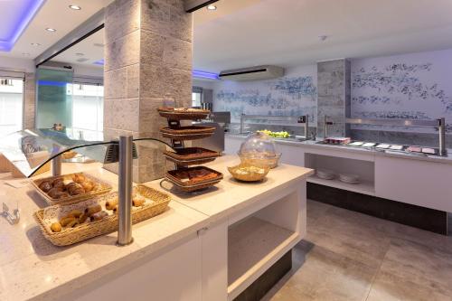 a kitchen with a counter with some food on it at Hotel Brisa Ibiza - Adults only in San Antonio