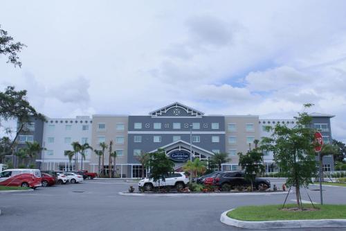 a large building with cars parked in a parking lot at Carlisle Inn Sarasota in Sarasota