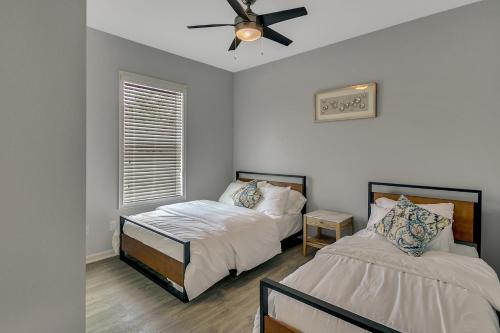 a bedroom with two beds and a ceiling fan at New 3/2 Duplex Minutes From Heart of Tampa -Unit B in Tampa