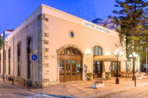 a large building with a clock on the front of it at Fortezza Hotel in Rethymno
