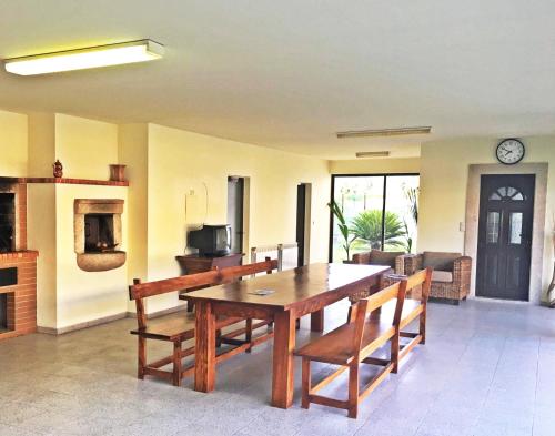 a dining room with a wooden table and chairs at Casa de Barreiros in Braga