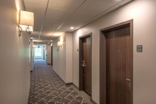 a corridor of an office with doors and carpet at Coast Oliver Hotel in Oliver