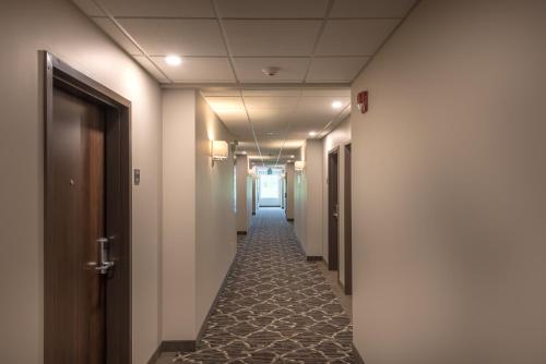 a corridor of a hallway with a long hallway at Coast Oliver Hotel in Oliver
