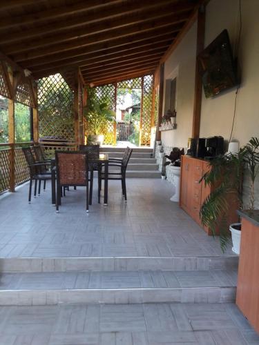 a patio with a table and chairs in a pavilion at Georgievi Guest House in Sapareva Banya