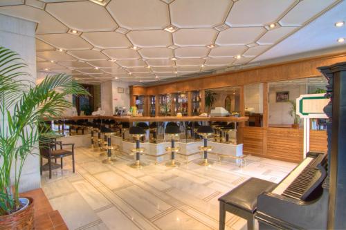 a bar in a restaurant with chairs and a table at Fortezza Hotel in Rethymno Town