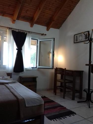 a bedroom with a bed and a mirror and a chair at Amarantos in Loutra Amarantou