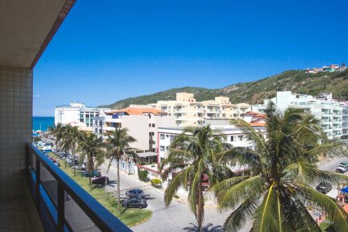 a view of a city with palm trees and the ocean at Edificio caminho do sol in Arraial do Cabo