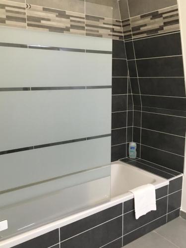 安锡The Boat的浴室设有浴缸,铺有黑白瓷砖。