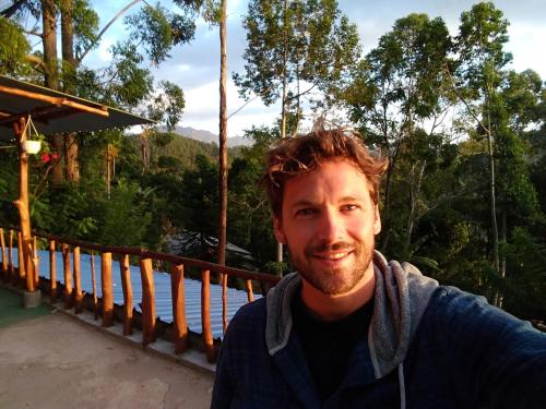 a man is posing for a picture on a bridge at Apurvi Homestay in Ella