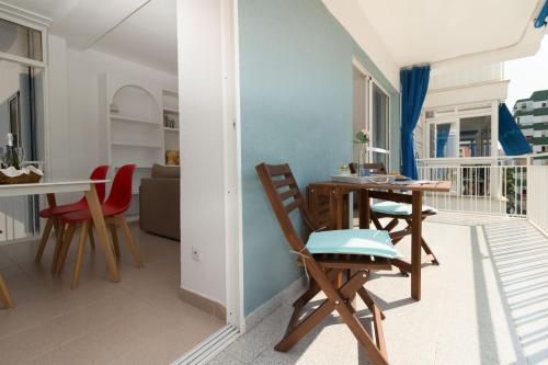 a living room with a table and chairs on a balcony at Oporto in Benicàssim
