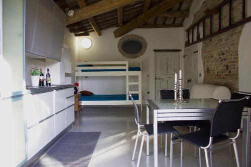 a kitchen and dining room with a table and a bunk bed at Pan & Cioccolato in Bellaria-Igea Marina