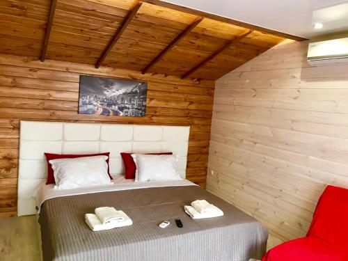 a bedroom with a bed in a wooden wall at Эко отель Прованс Одесса in Odesa