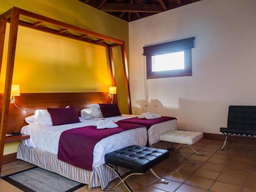 a hotel room with two beds and a window at La Casona del Patio in Santiago del Teide