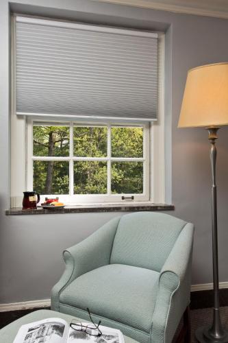 a living room with a chair and a window at Gideon Putnam Resort & Spa in Saratoga Springs