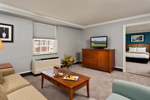 a living room with a couch and a table at Gideon Putnam Resort & Spa in Saratoga Springs
