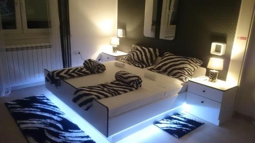 a living room with a couch with zebra pillows on it at Center Una Apartment in Bihać