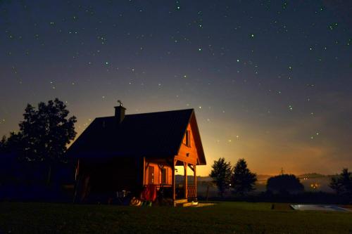 a barn at night with the stars in the sky at Domek Skowronek z basenem in Lesko