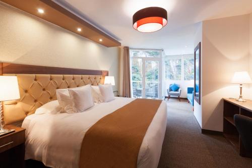 Postel nebo postele na pokoji v ubytování Inti Punku Machupicchu Hotel & Suites