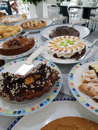a table topped with plates of cakes and pastries at Villaggio La Pescaccia in San Clemente