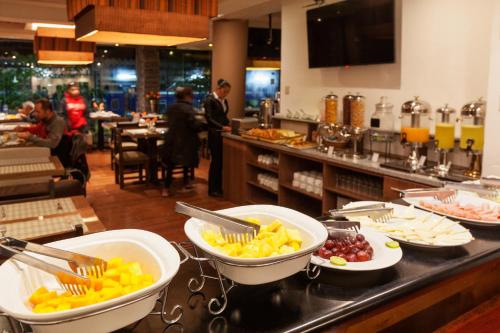 a buffet line with plates of food in a restaurant at Inti Punku Machupicchu Hotel & Suites in Machu Picchu