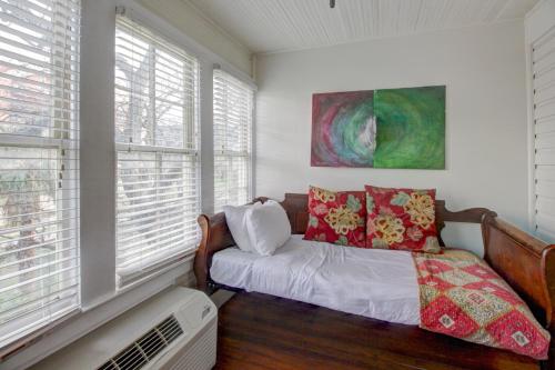 a bedroom with a bed and a fan and windows at Inn on the Riverwalk in San Antonio
