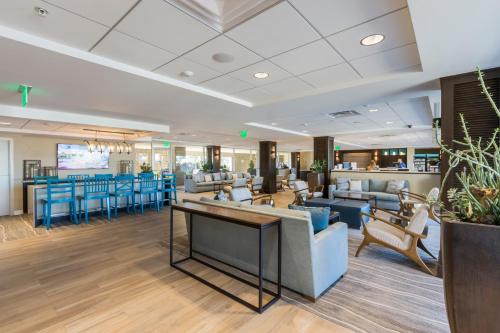 a lobby with couches and chairs and a bar at Carlsbad Seapointe Resort in Carlsbad