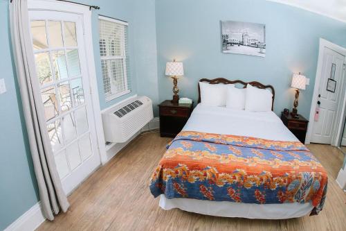a bedroom with a bed and a large window at Inn on the Riverwalk in San Antonio